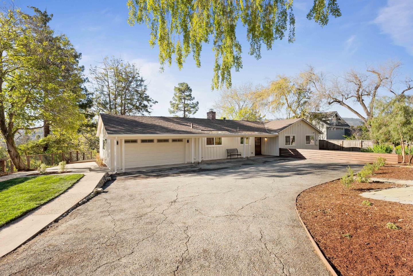 955 Palomar Drive Redwood City, CA 94062 - Photo 1 of 51 a front view of a house with a yard and garage