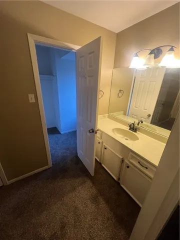 a bathroom with a double vanity sink and mirror