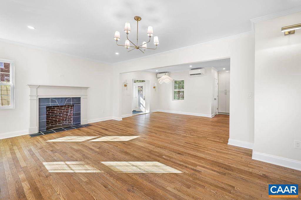 809 East Jefferson Street Charlottesville, VA 22902 - Photo 10 of 50 a view of an empty room with wooden floor fireplace and a window