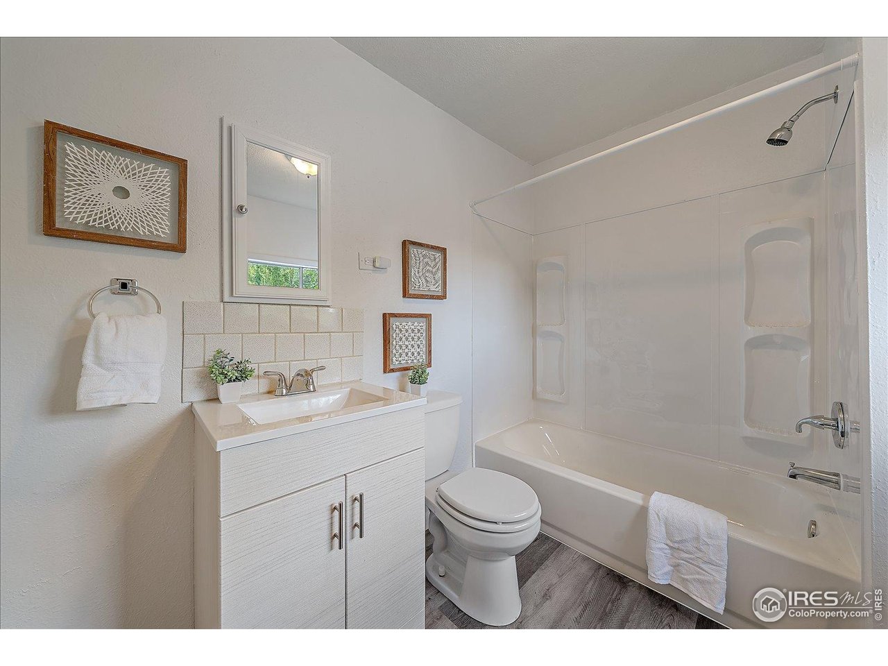 131 3rd Street Dacono, CO 80514 - Photo 12 of 28 a bathroom with a sink a toilet and shower