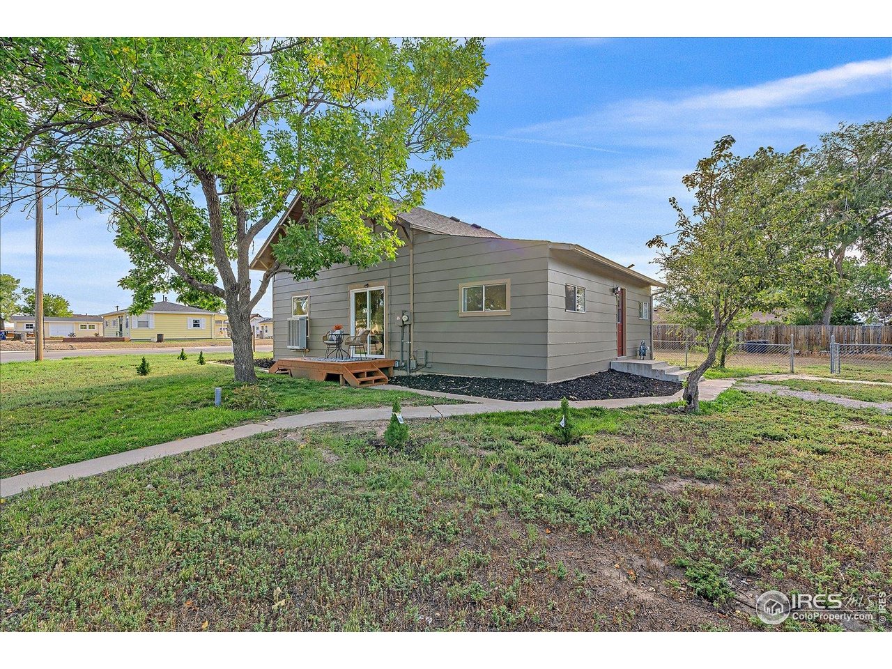 131 3rd Street Dacono, CO 80514 - Photo 17 of 28 a backyard of a house with lots of green space