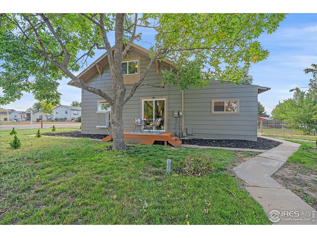 131 3rd Street Dacono, CO 80514 - Photo 18 of 28 a front view of house with yard and green space