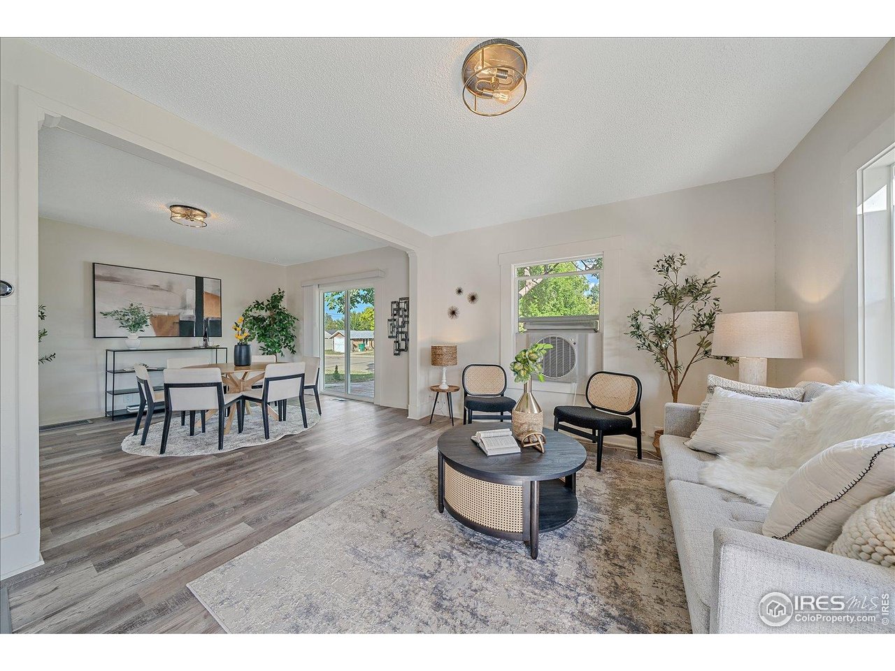 131 3rd Street Dacono, CO 80514 - Photo 4 of 28 a living room with furniture and a wooden floor