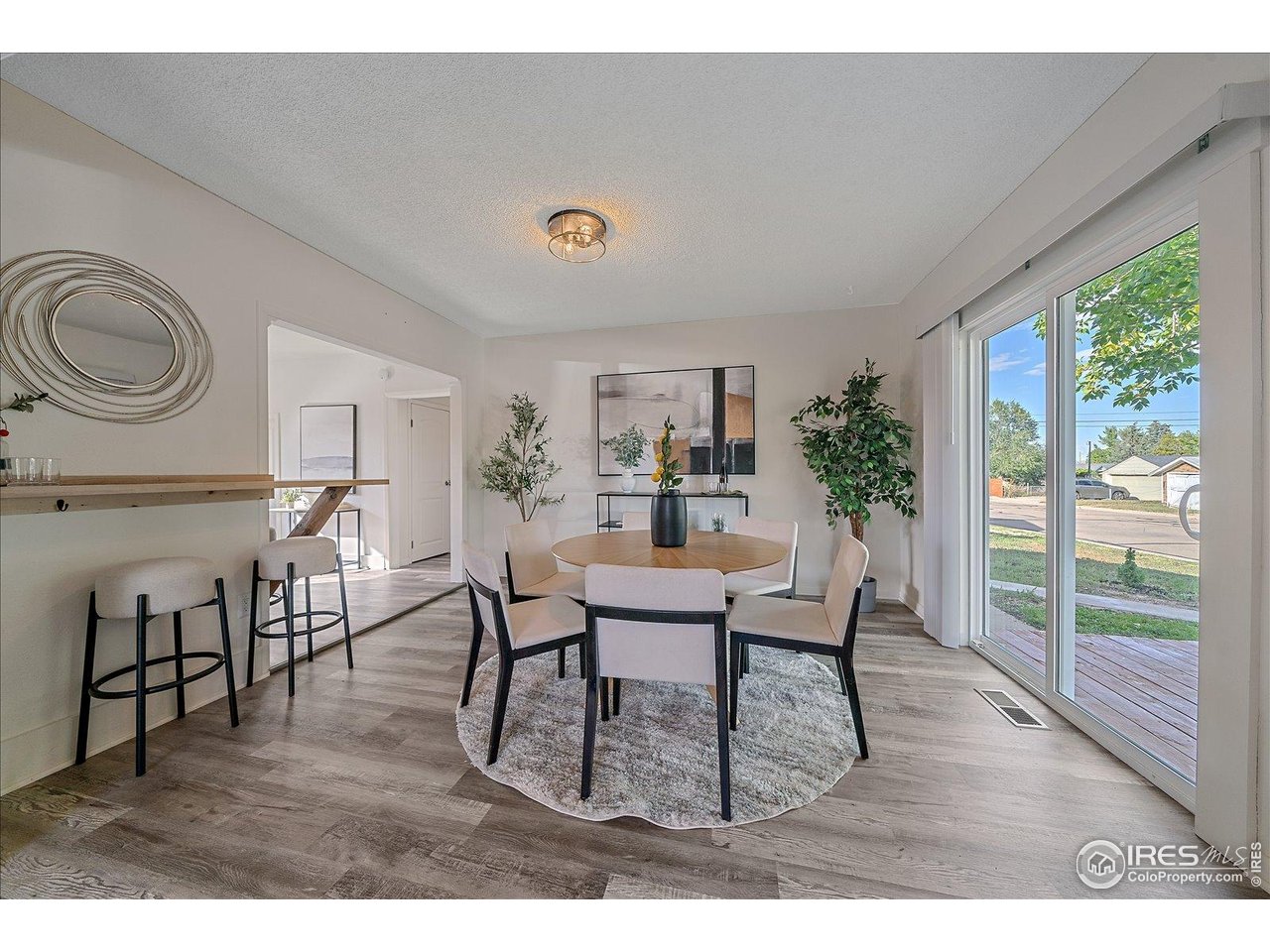 131 3rd Street Dacono, CO 80514 - Photo 6 of 28 a living room with furniture and a wooden floor