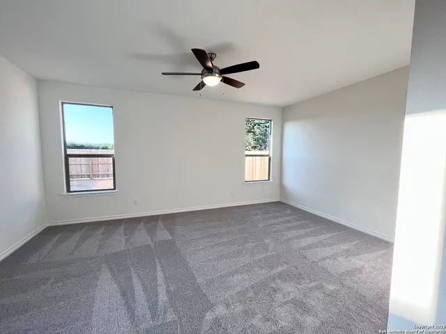 a bathroom with a tub a sink and mirrors