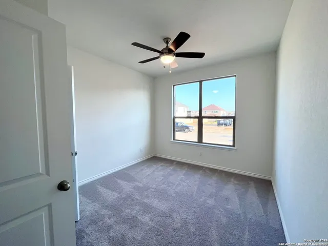 a view of a big room with wooden floor closet and windows