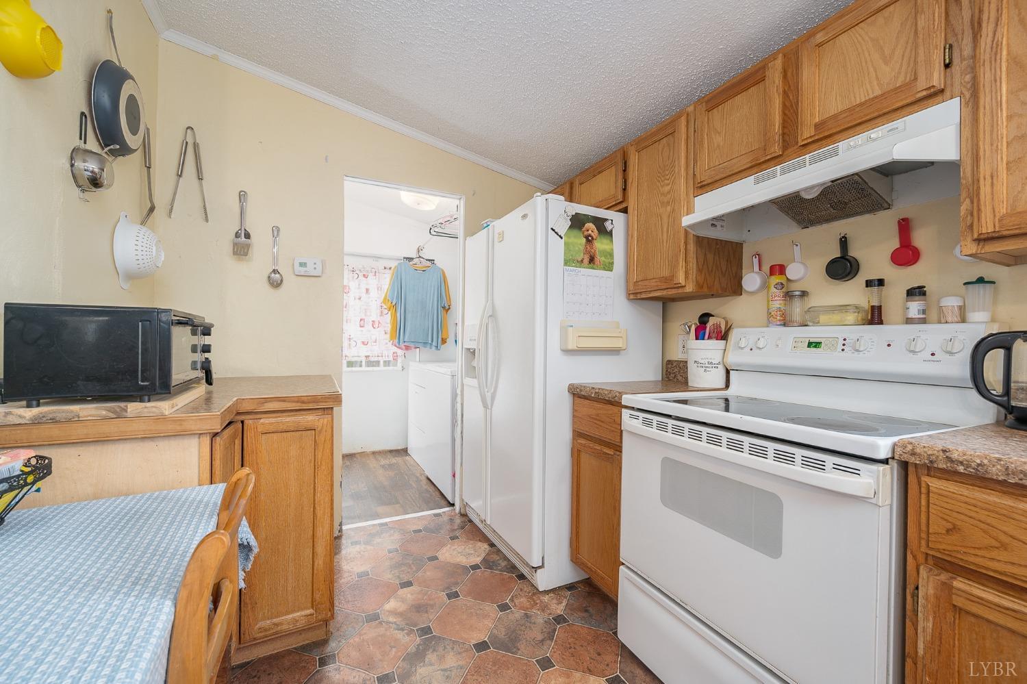1105 Veteran Road Vinton, VA 24179 - Photo 13 of 37 a kitchen with stainless steel appliances granite countertop a refrigerator and a stove top oven