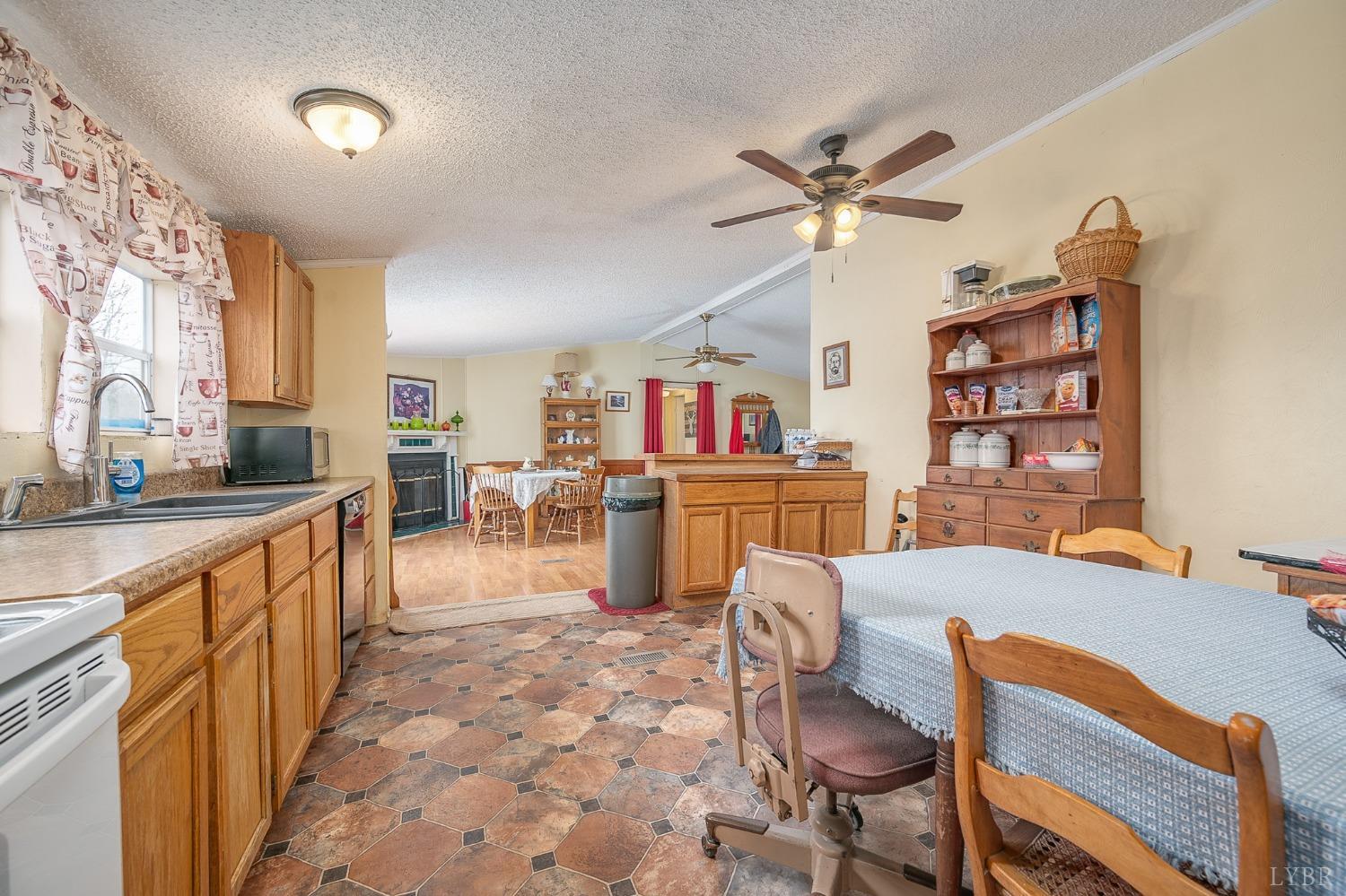 1105 Veteran Road Vinton, VA 24179 - Photo 15 of 37 a living room with lots of furniture and kitchen view