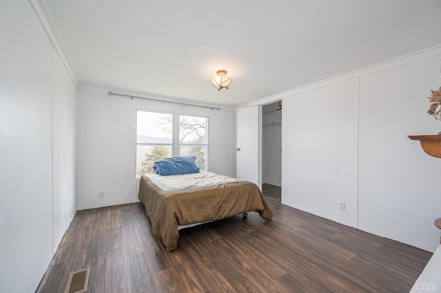 1105 Veteran Road Vinton, VA 24179 - Photo 16 of 37 a bedroom with a bed and wooden floor