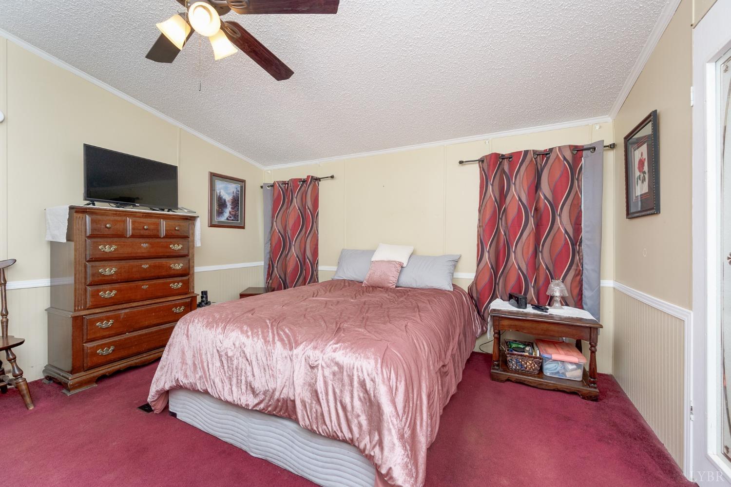 1105 Veteran Road Vinton, VA 24179 - Photo 21 of 37 a bedroom with a bed and a chandelier