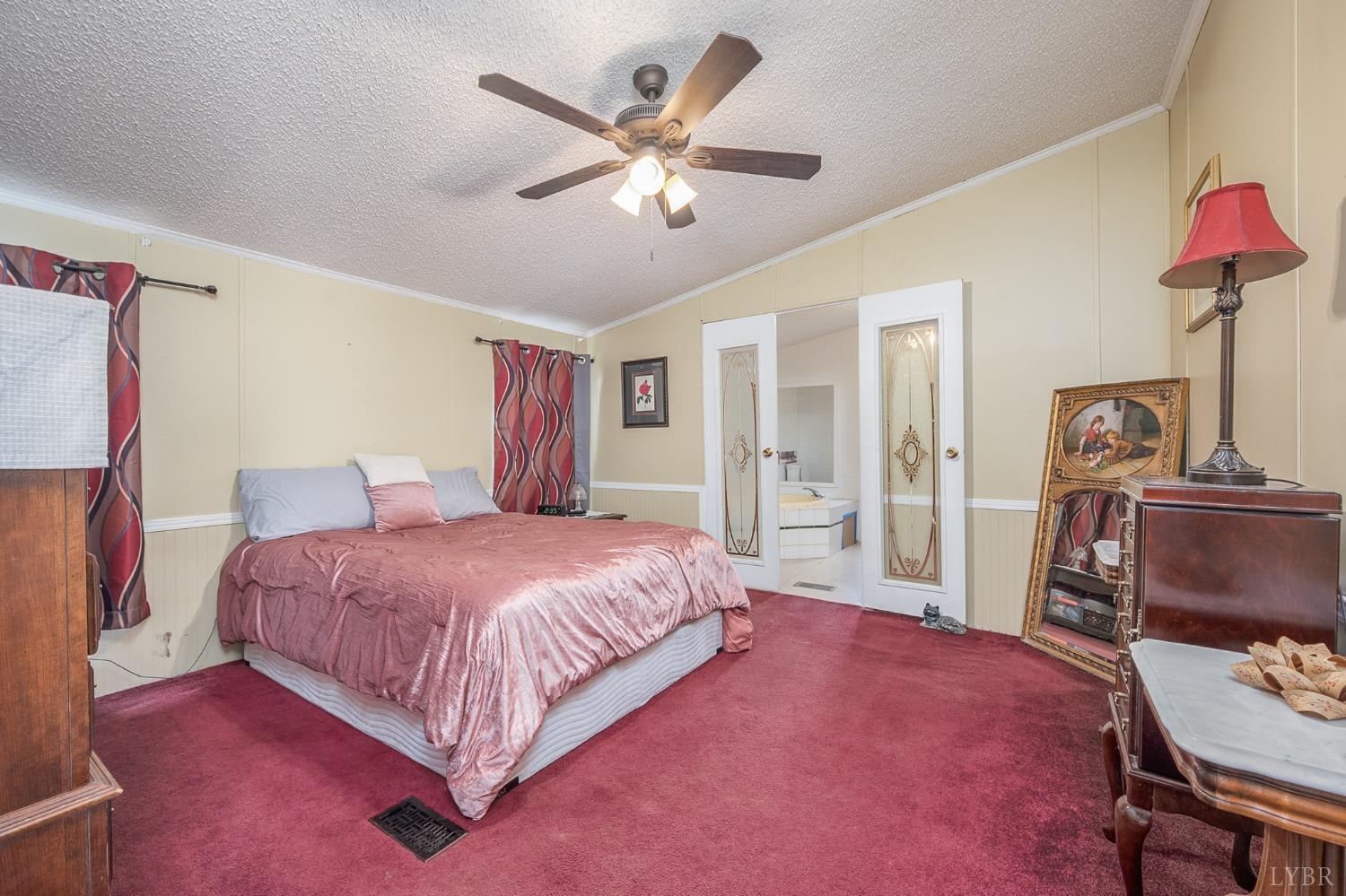 1105 Veteran Road Vinton, VA 24179 - Photo 22 of 37 a bedroom with a bed chandelier and a window