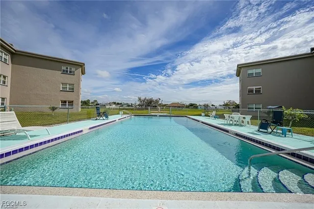 a view of a swimming pool with an outdoor seating