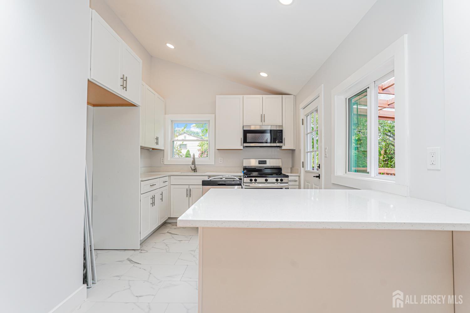 20 Daniel Road Spotswood, NJ 08884 - Photo 12 of 29 a kitchen with stainless steel appliances a refrigerator sink and microwave