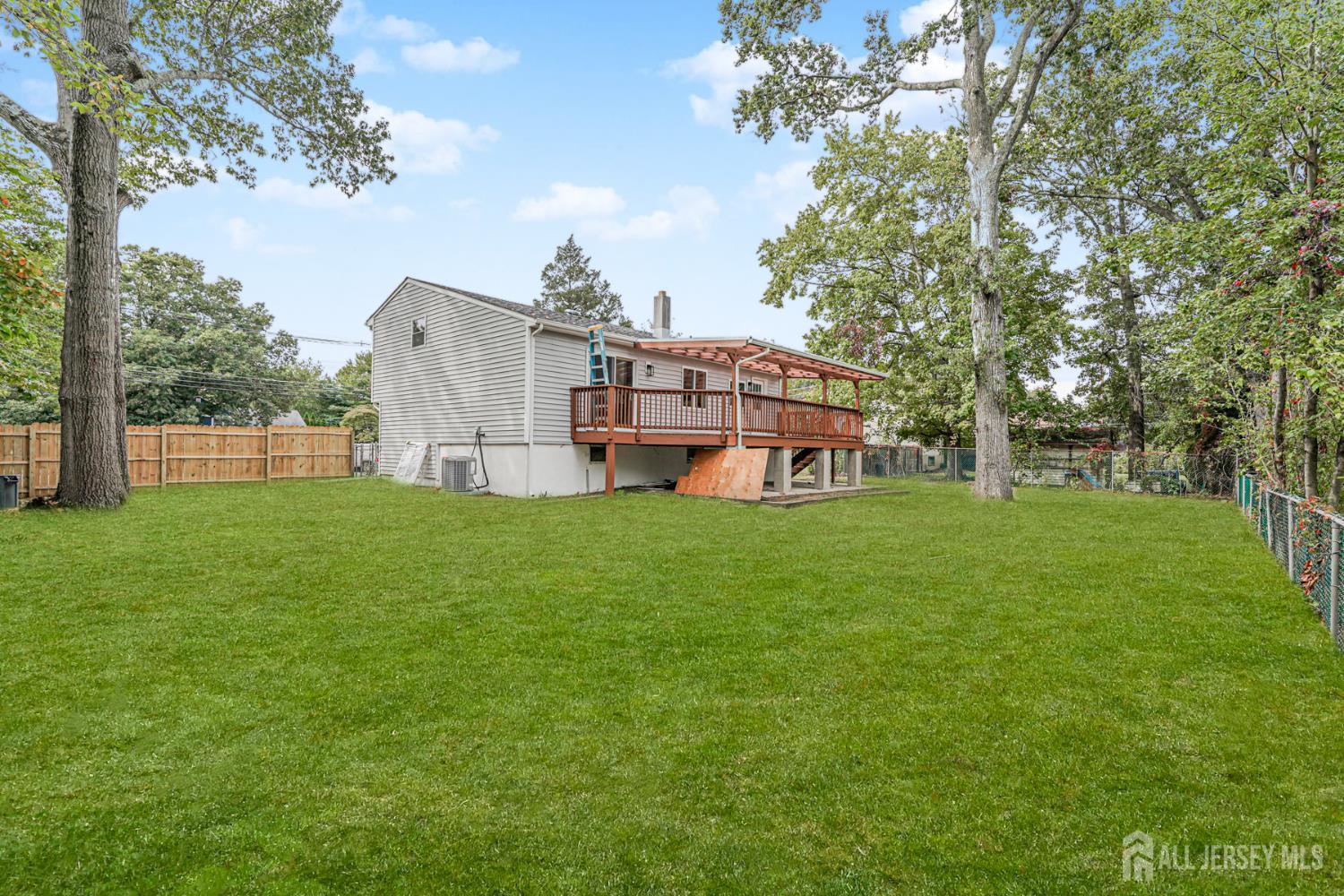 20 Daniel Road Spotswood, NJ 08884 - Photo 27 of 29 a view of a house with a big yard and large trees