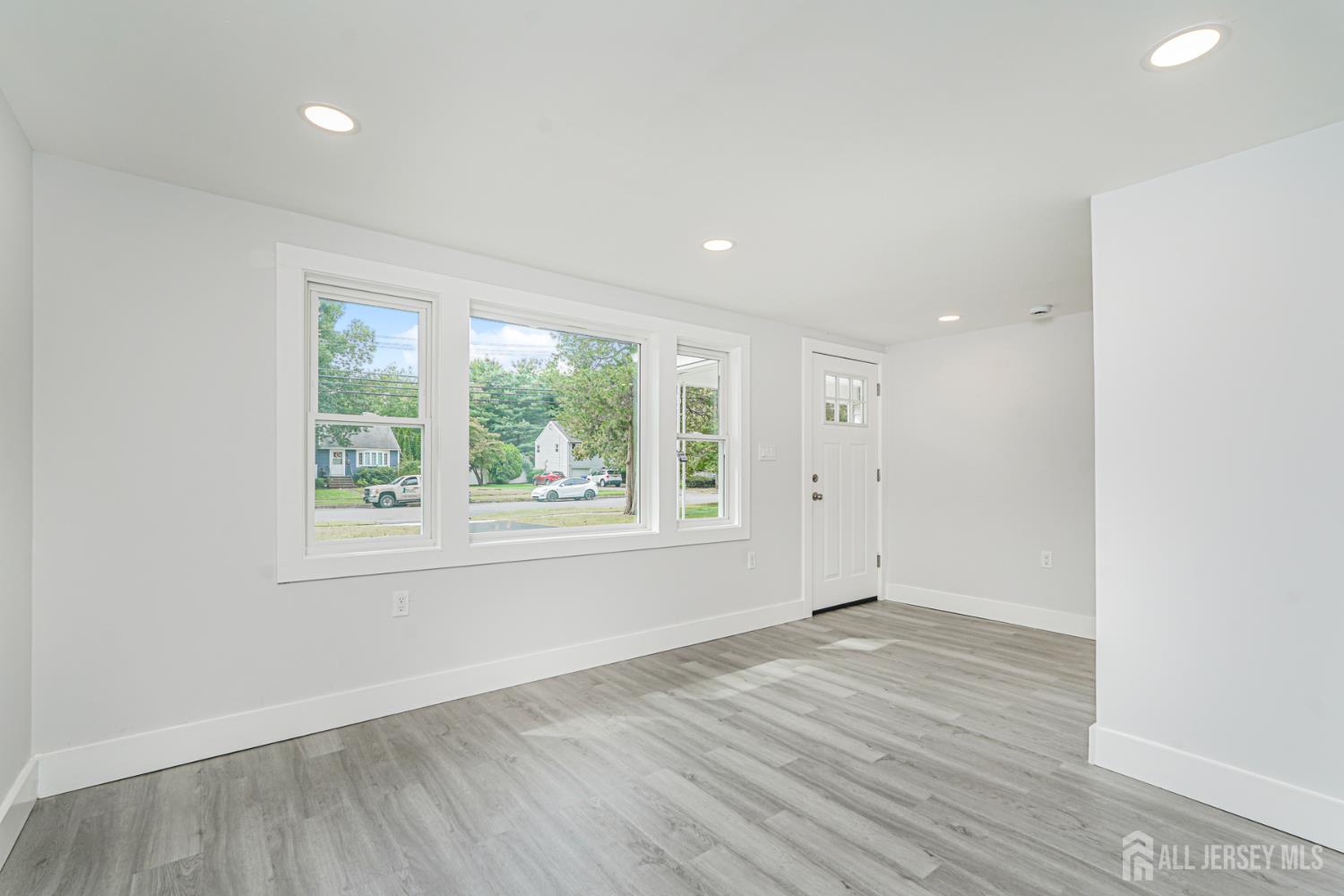 20 Daniel Road Spotswood, NJ 08884 - Photo 4 of 29 an empty room with wooden floor and windows