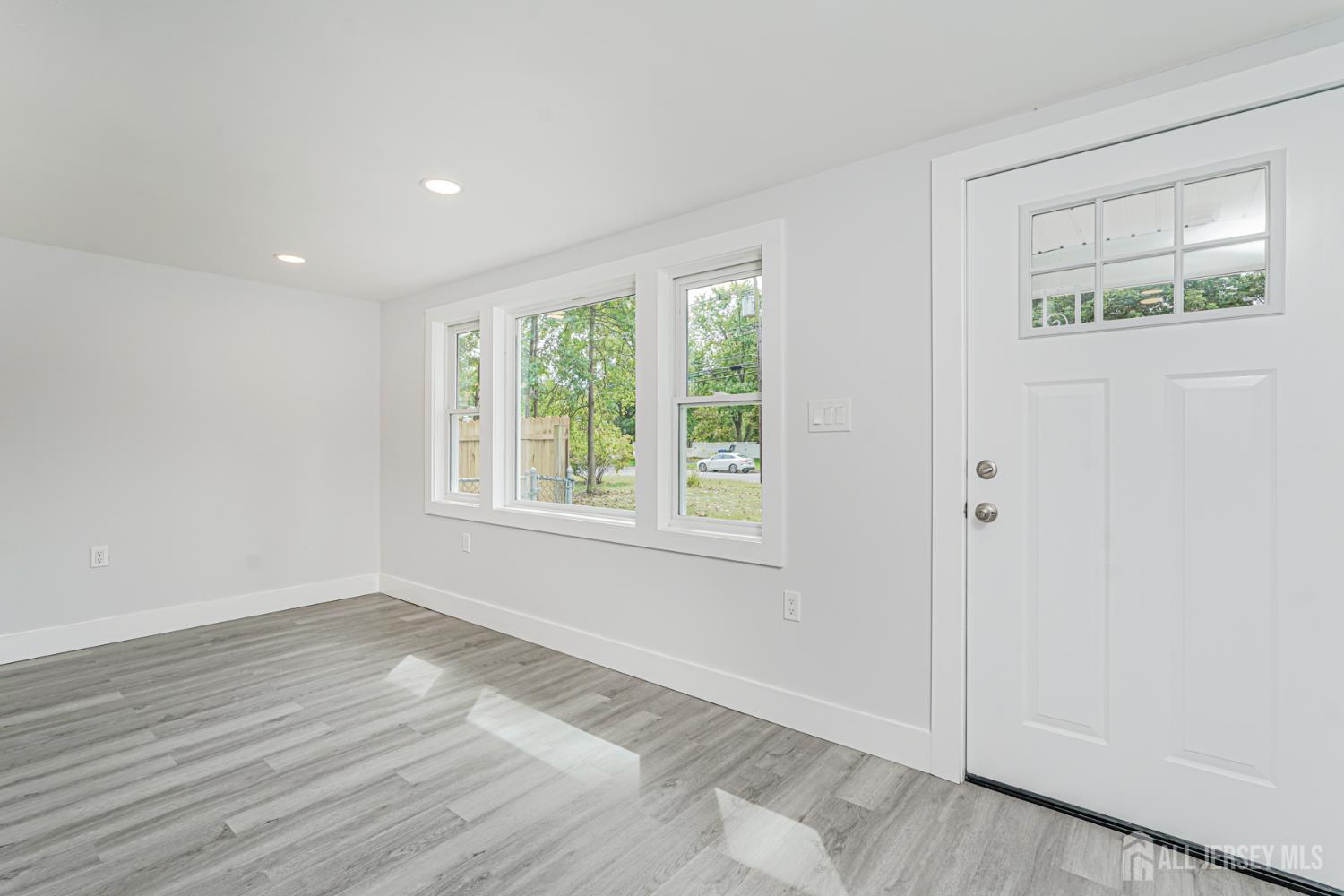20 Daniel Road Spotswood, NJ 08884 - Photo 5 of 29 a view of an empty room with wooden floor and a window
