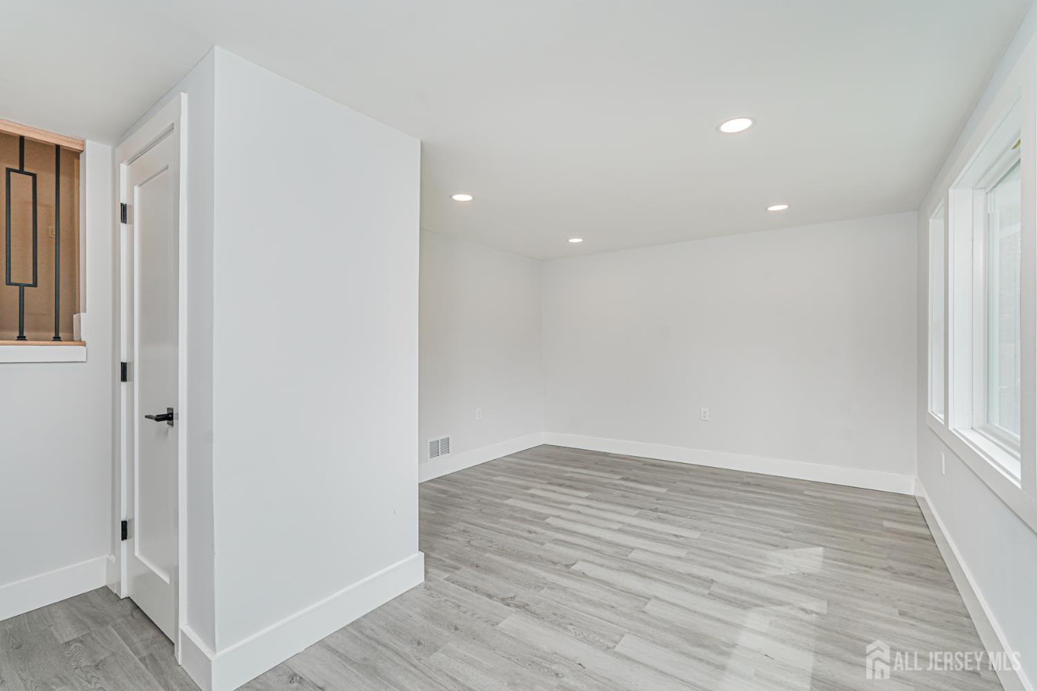 20 Daniel Road Spotswood, NJ 08884 - Photo 6 of 29 wooden floor in an empty room with a window