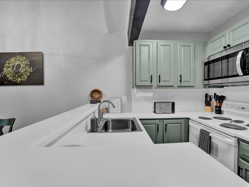 216 Snow Ridge Cir Lake Lake Harmony, PA 18624 - Photo 14 of 43 a kitchen with kitchen island a sink stainless steel appliances and cabinets