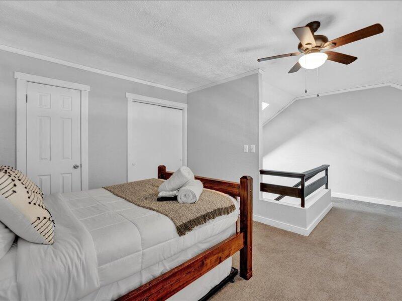 216 Snow Ridge Cir Lake Lake Harmony, PA 18624 - Photo 24 of 43 a bedroom with a bed a lamp and a chandelier