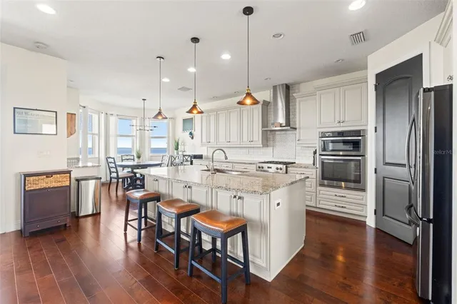 a view of a dining room with furniture and wooden floor