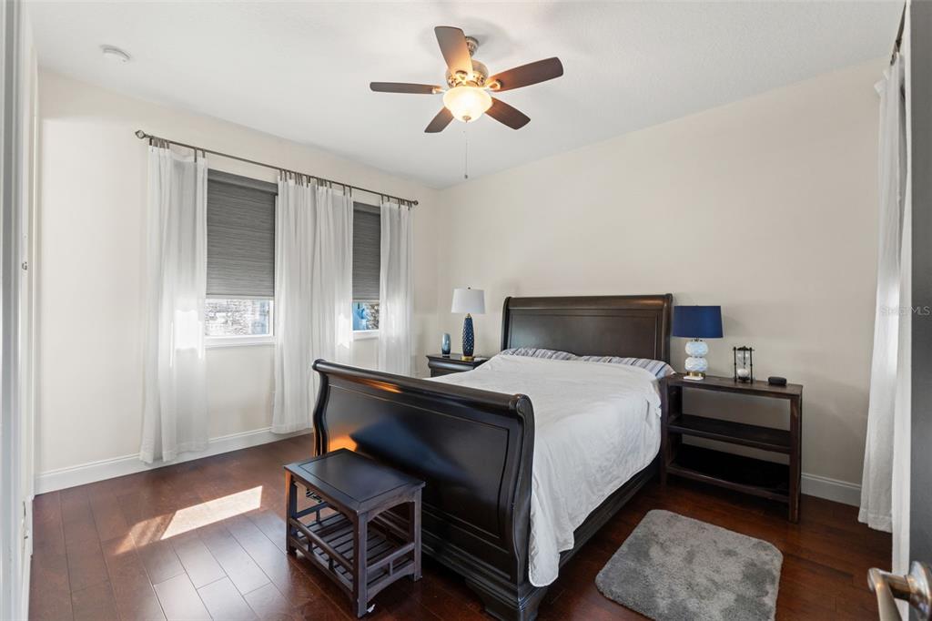 4387 Harborpointe Drive Port Richey, FL 34668 - Photo 28 of 46 a bedroom with bed and wooden floor