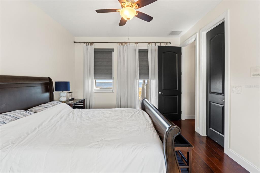 4387 Harborpointe Drive Port Richey, FL 34668 - Photo 29 of 46 a bedroom with a bed and a chandelier