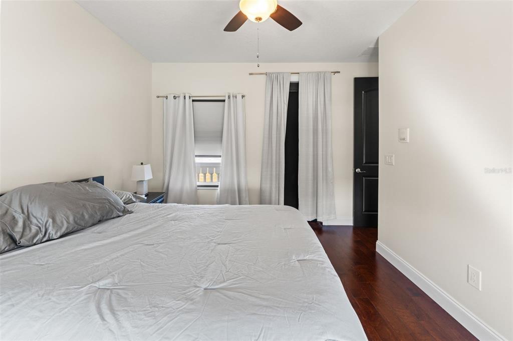 4387 Harborpointe Drive Port Richey, FL 34668 - Photo 42 of 46 a bedroom with a large bed and a chandelier