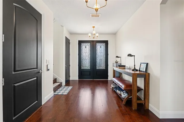 an open kitchen with granite countertop a refrigerator and kitchen island