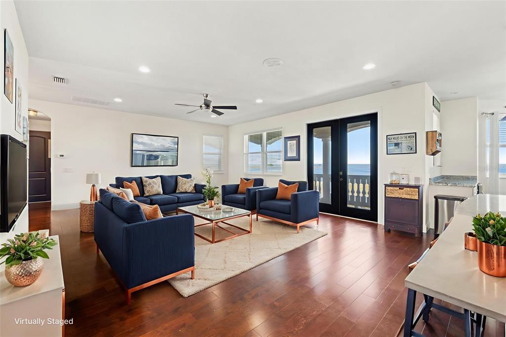 4387 Harborpointe Drive Port Richey, FL 34668 - Photo 9 of 46 a living room with furniture wooden floor and a flat screen tv