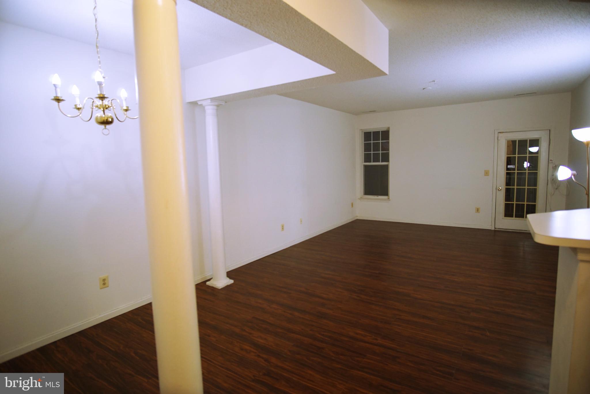 7115 Sandown Circle, Unit 202 Windsor Mill, MD 21244 - Photo 21 of 58 a view of empty room with wooden floor
