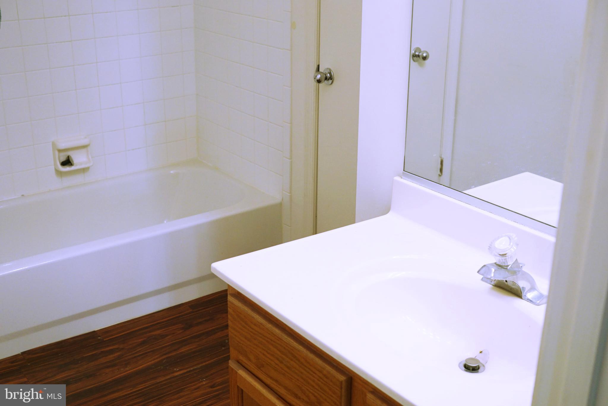 7115 Sandown Circle, Unit 202 Windsor Mill, MD 21244 - Photo 29 of 58 a bathroom with a tub and shower