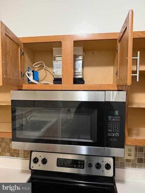 7115 Sandown Circle, Unit 202 Windsor Mill, MD 21244 - Photo 30 of 58 a stove top oven sitting inside of a kitchen