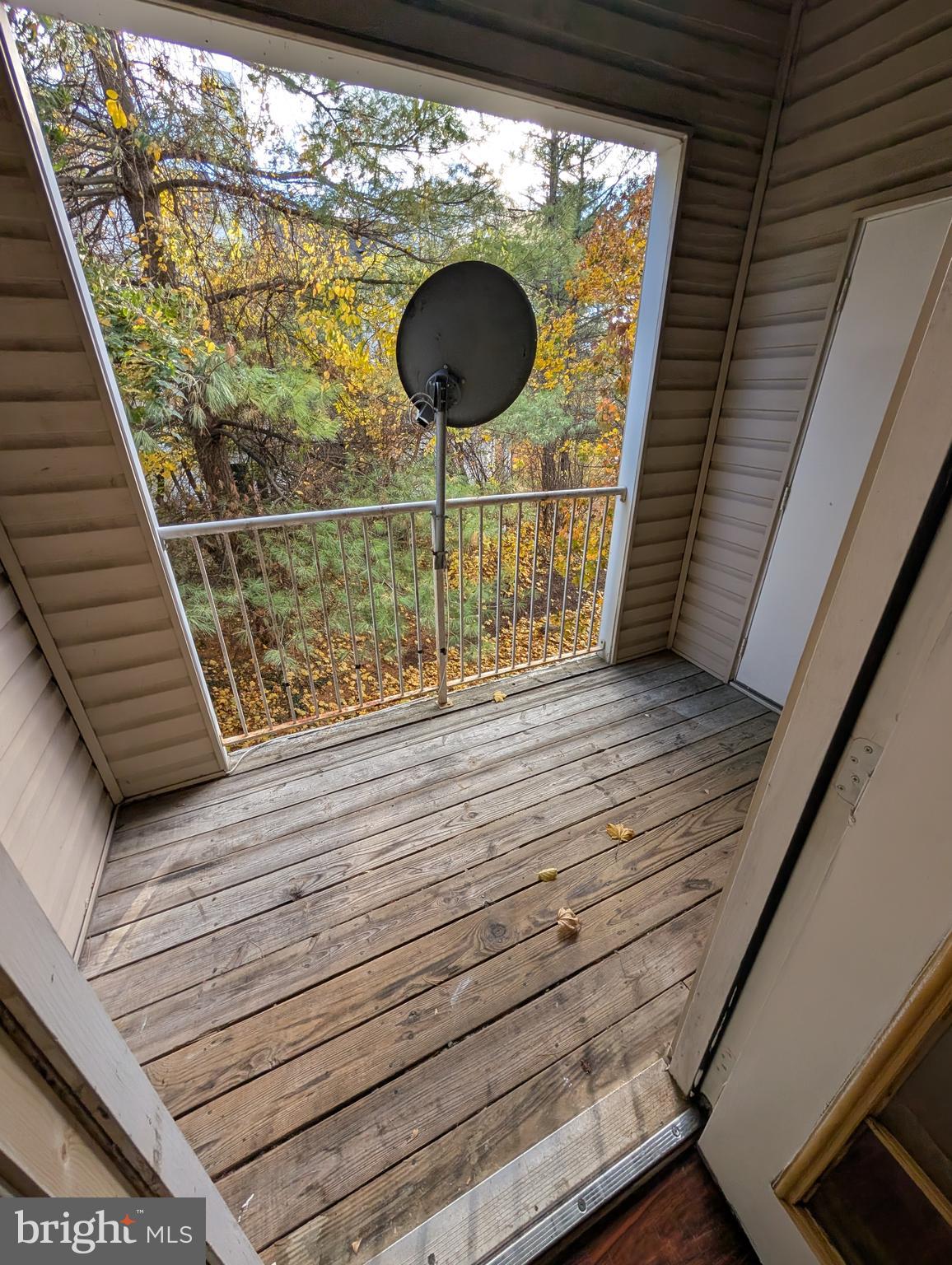 7115 Sandown Circle, Unit 202 Windsor Mill, MD 21244 - Photo 48 of 58 a balcony with table and chairs