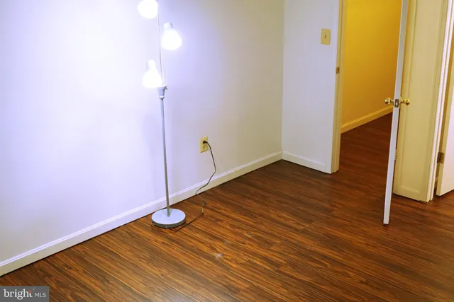 a view of a room with wooden floor