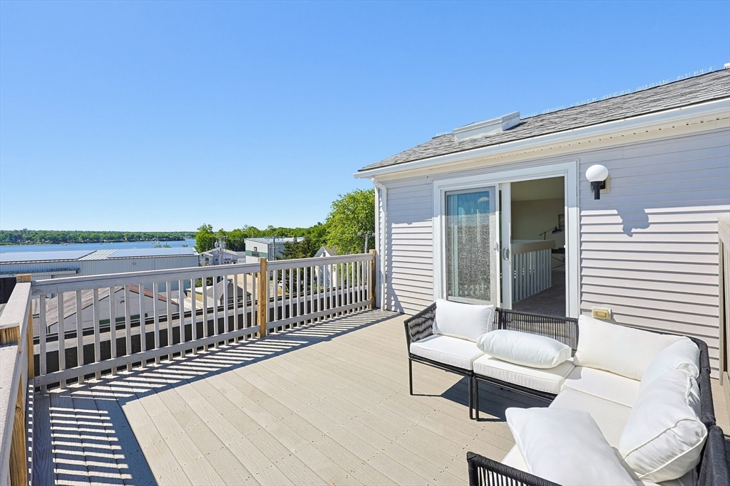 45 Main Street, Unit 35 Wareham, MA 02571 - Photo 2 of 34 a balcony with wooden floor table and chairs