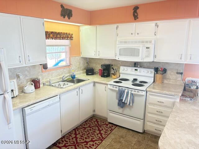 5731 West Flying M Street Tucson, AZ 85713 - Photo 13 of 20 a kitchen with white cabinets sink and white appliances