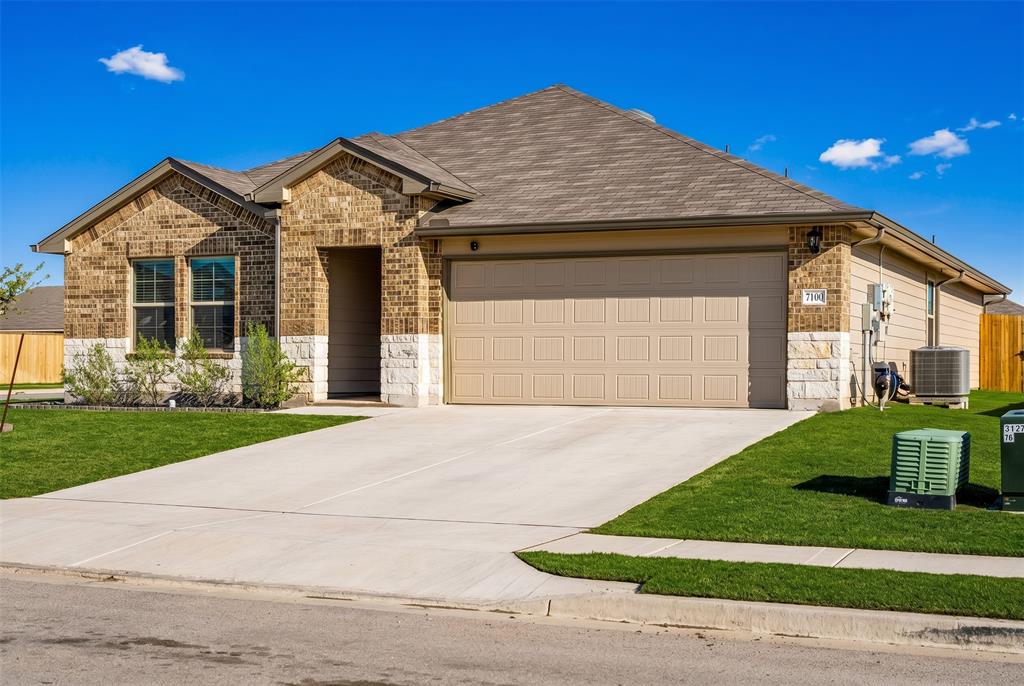 7100 Canadian Drive China Spring, TX 76633 - Photo 2 of 16 a front view of a house with a yard and garage