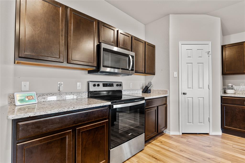 7100 Canadian Drive China Spring, TX 76633 - Photo 5 of 16 a kitchen with stainless steel appliances a stove microwave and refrigerator