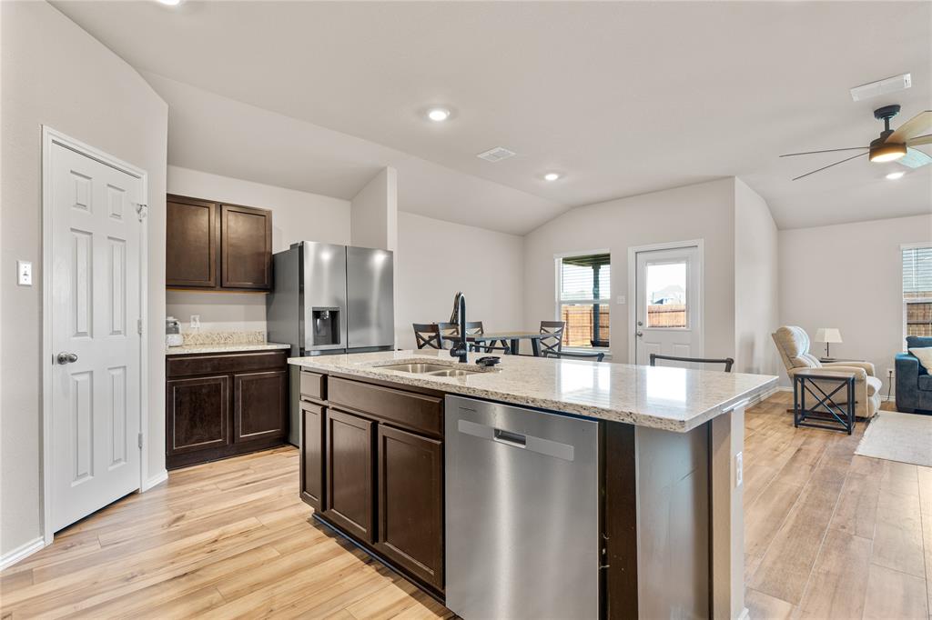 7100 Canadian Drive China Spring, TX 76633 - Photo 15 of 16 a kitchen with stainless steel appliances granite countertop a sink stove and refrigerator