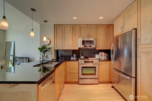 a kitchen with kitchen island a counter appliances and cabinets