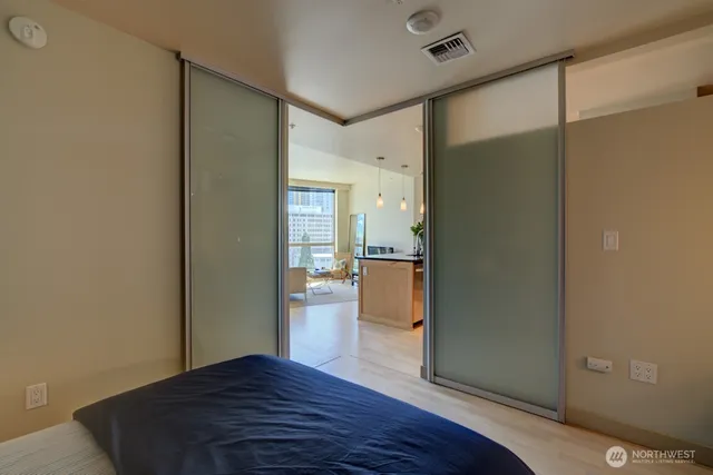 a view of kitchen with refrigerator and wooden floor