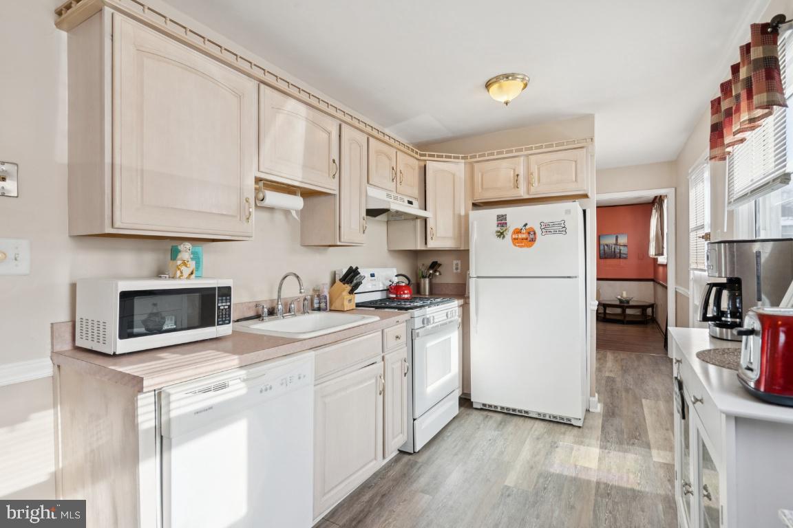 21 Paul Road Maple Shade, NJ 08052 - Photo 9 of 25 a kitchen with stainless steel appliances granite countertop a refrigerator sink stove and white cabinets