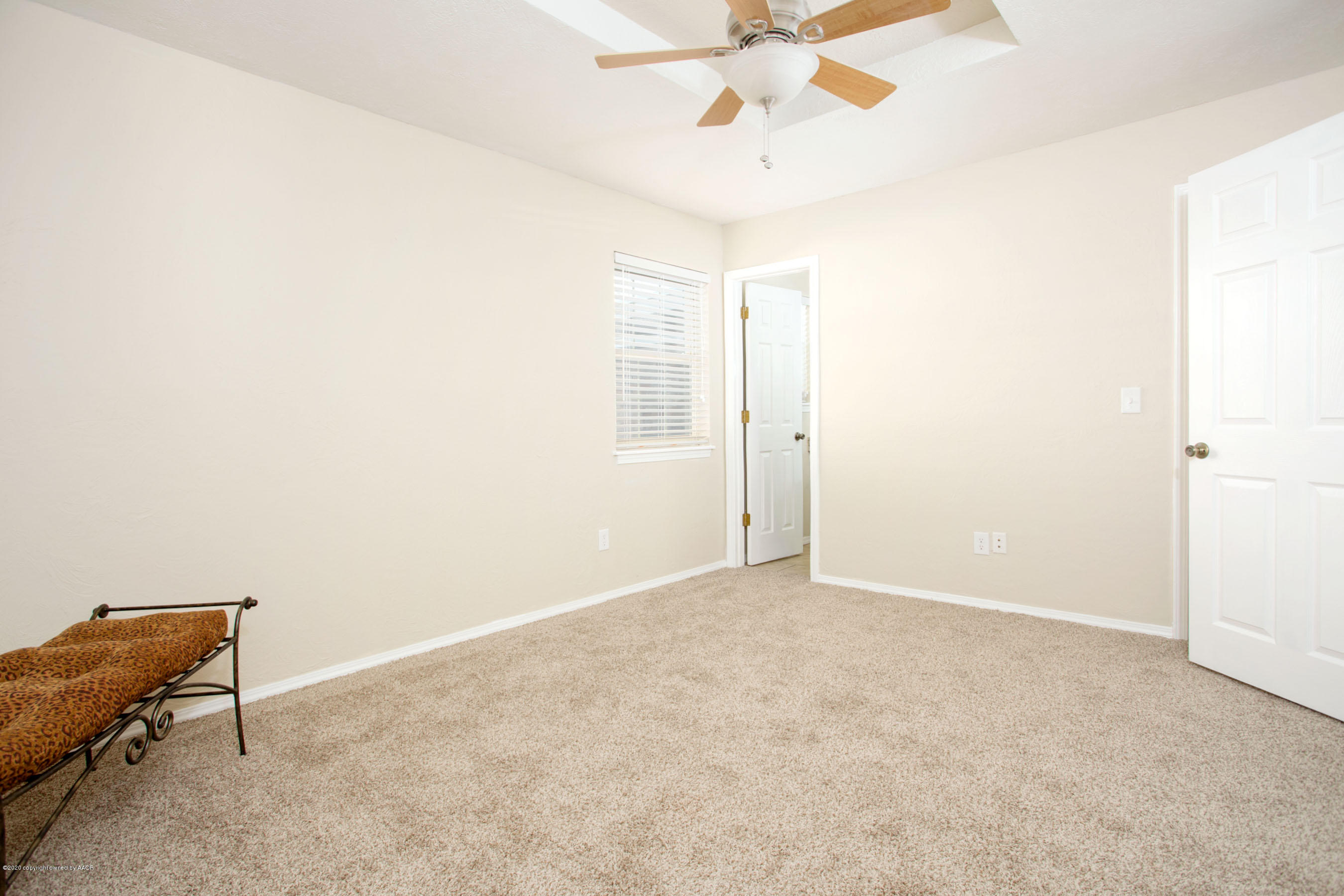 5104 Pin Oak Drive Amarillo, TX 79110 - Photo 13 of 20 an empty room with a ceiling fan and wooden floor