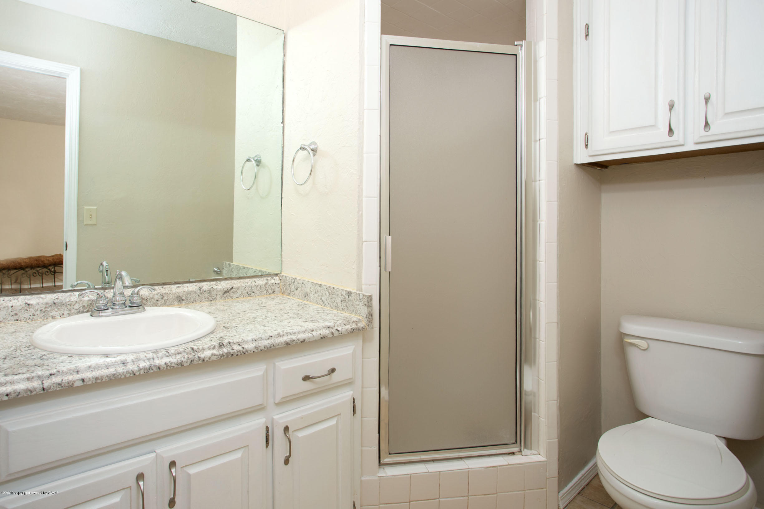 5104 Pin Oak Drive Amarillo, TX 79110 - Photo 18 of 20 a bathroom with a granite countertop sink toilet and shower