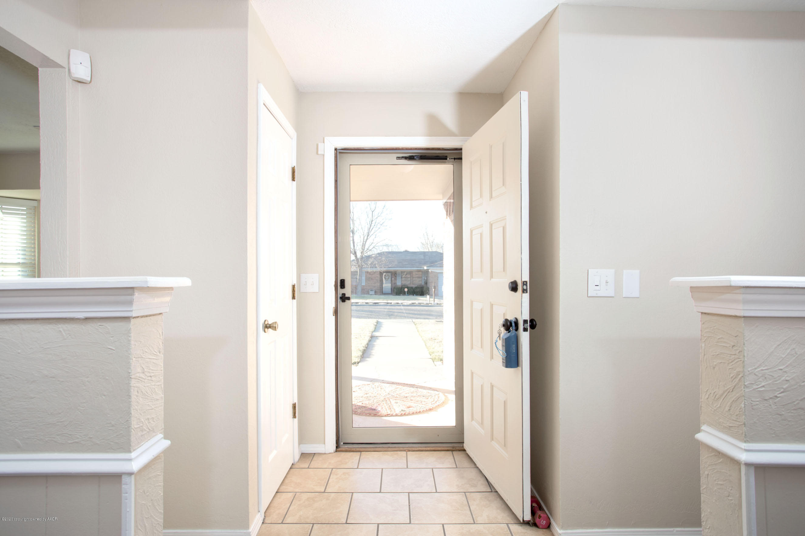 5104 Pin Oak Drive Amarillo, TX 79110 - Photo 6 of 20 a view of a hallway with wooden floor and a bathroom