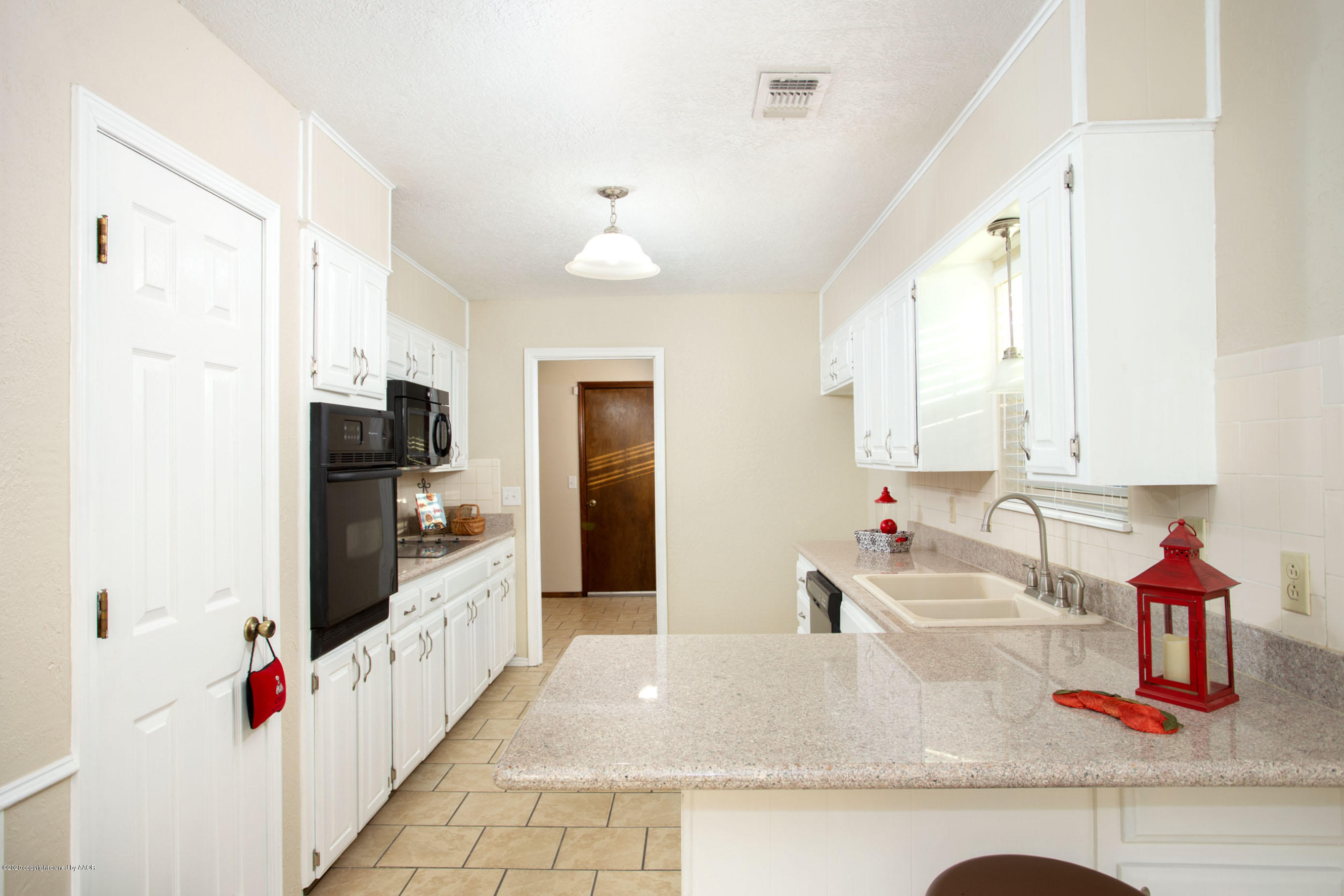 5104 Pin Oak Drive Amarillo, TX 79110 - Photo 7 of 20 a kitchen with sink refrigerator and microwave