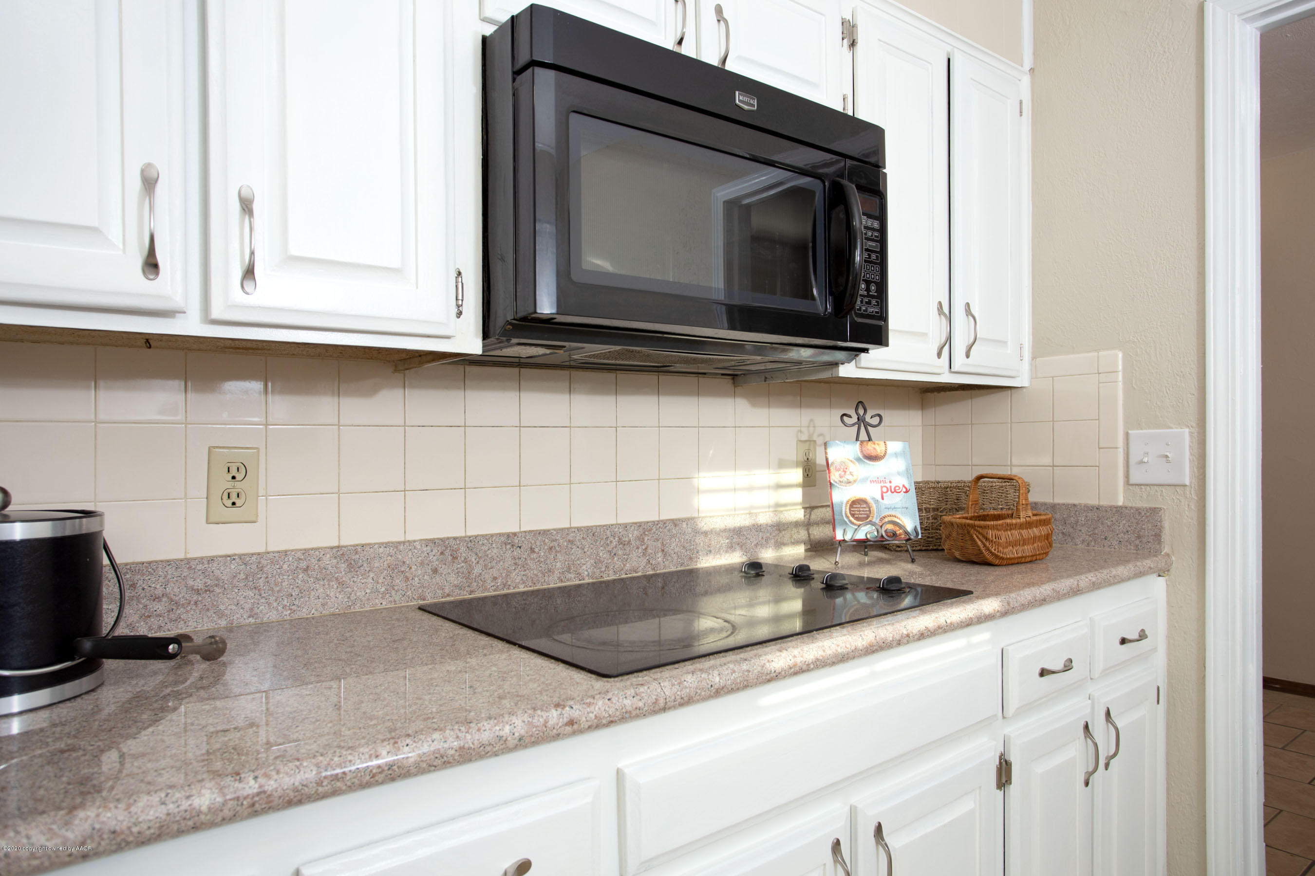 5104 Pin Oak Drive Amarillo, TX 79110 - Photo 8 of 20 a kitchen with granite countertop white cabinets and a microwave