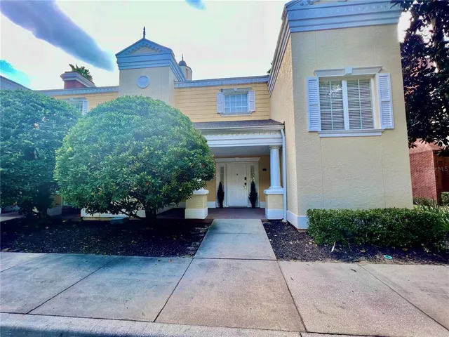 a view of a house with potted plants