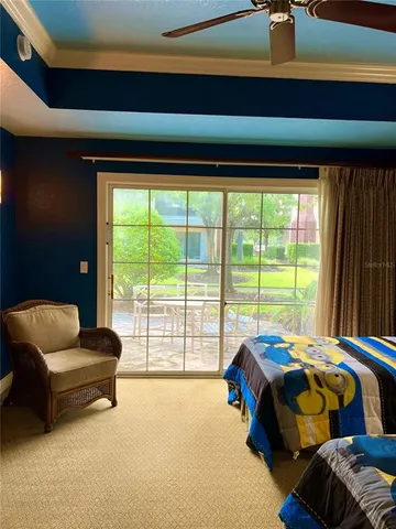 a bedroom with furniture and large windows