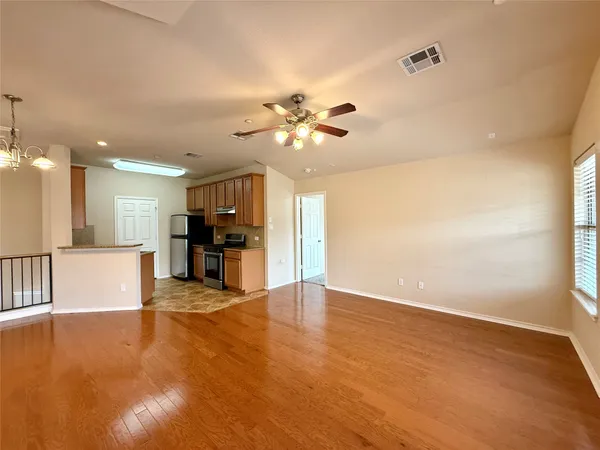 a kitchen with a refrigerator stove and cabinets